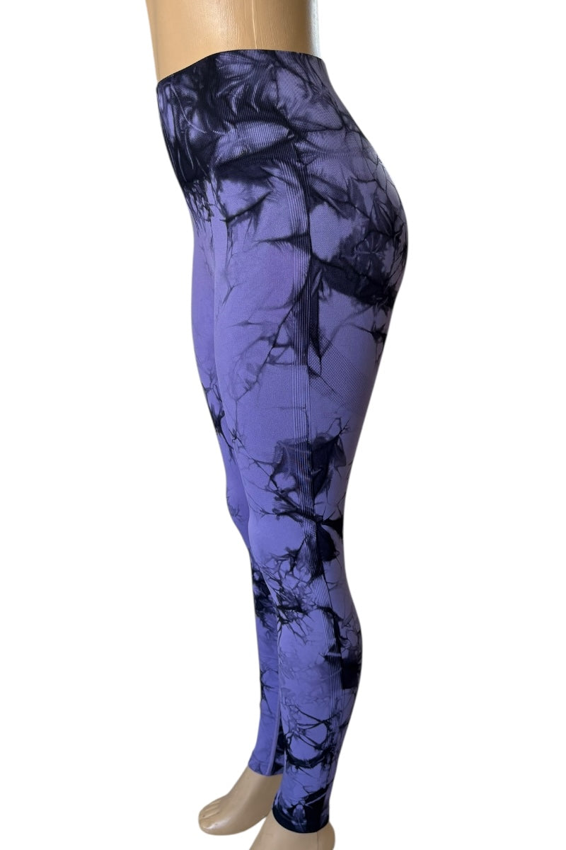 Purple and black patterned leggings on a mannequin against a white background