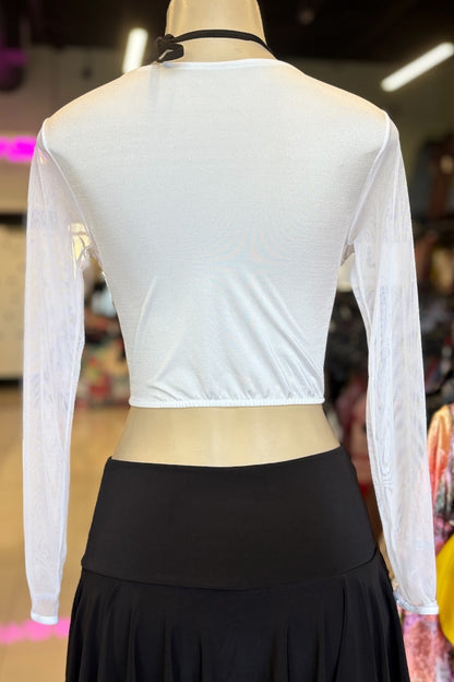 Mannequin wearing a white long-sleeve top and black skirt in an indoor setting.