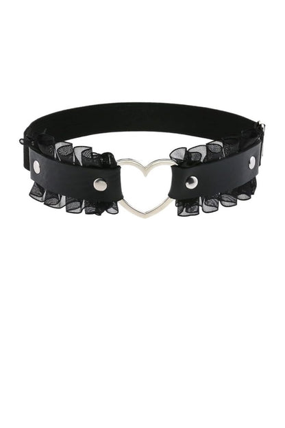 A black faux-leather leg garter featuring a central silver heart-shaped metal clasp and layered black sheer ruffled trim on both sides, displayed against a solid white background.