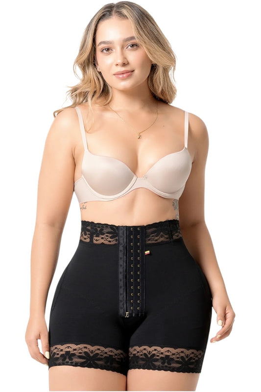 Woman wearing a beige bra and black shapewear with lace details on a white background