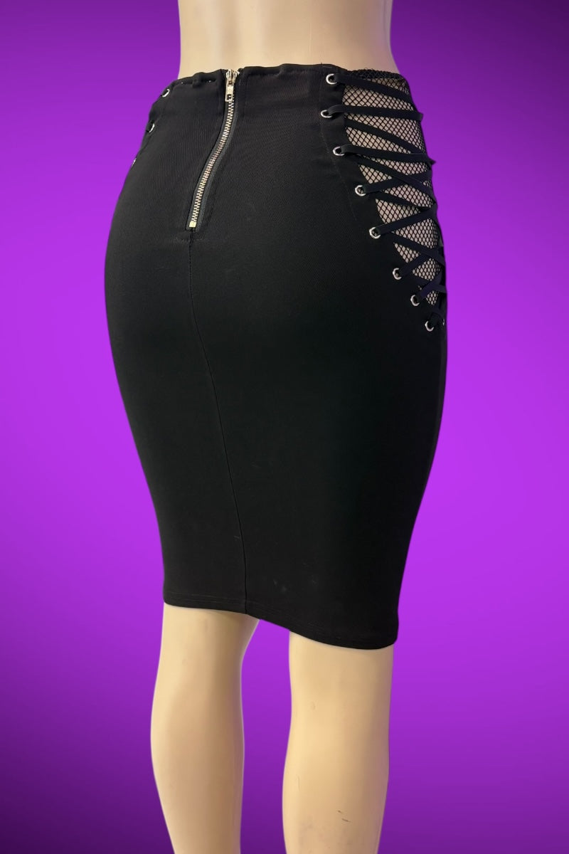 Black pencil skirt with lace-up side details on a purple background