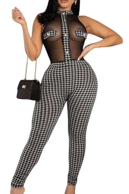Person wearing a black and white houndstooth patterned jumpsuit on a white background