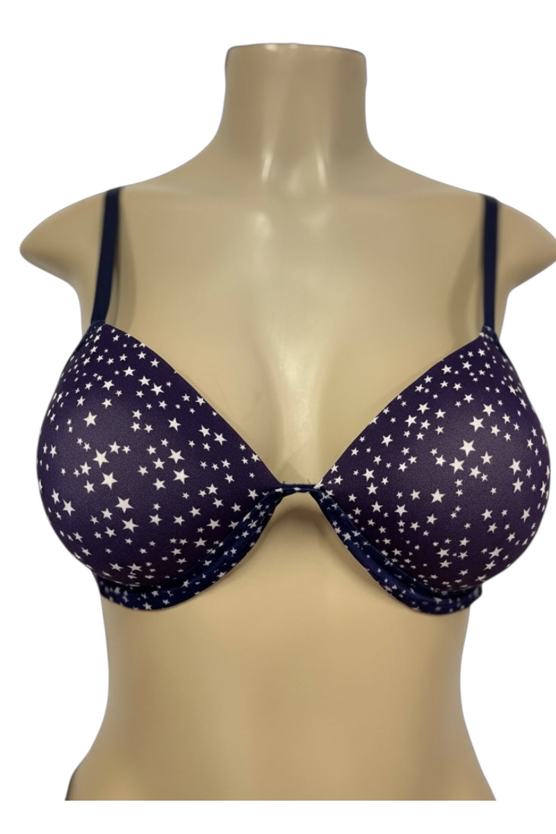 Navy blue bra with star pattern on a beige mannequin