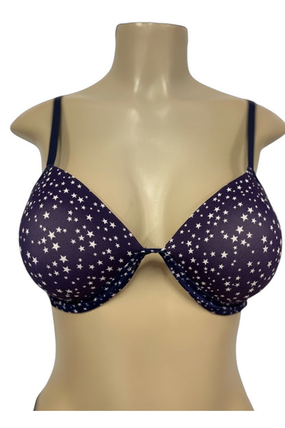 Navy blue bra with star pattern on a beige mannequin