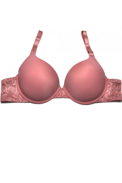 Pink bra with lace details on a white background