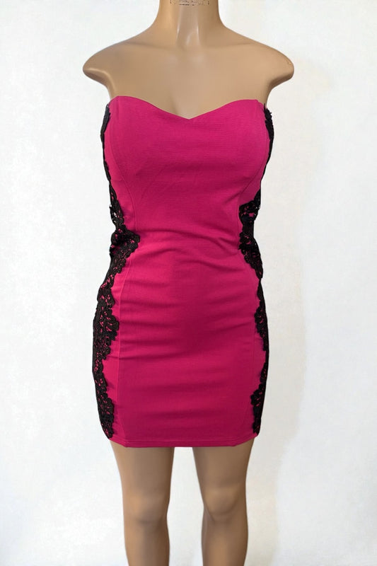 Pink strapless dress with black lace details on a mannequin against a white background