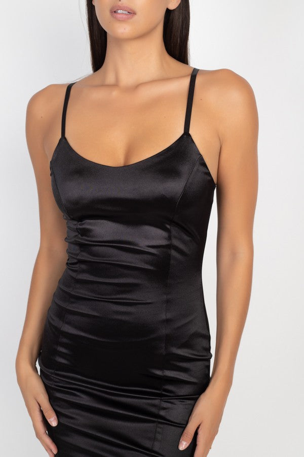 Black satin slip dress worn by a model on a white background