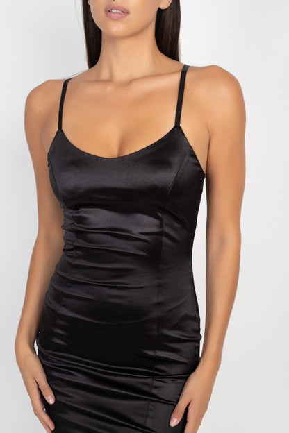 Black satin slip dress worn by a model on a white background