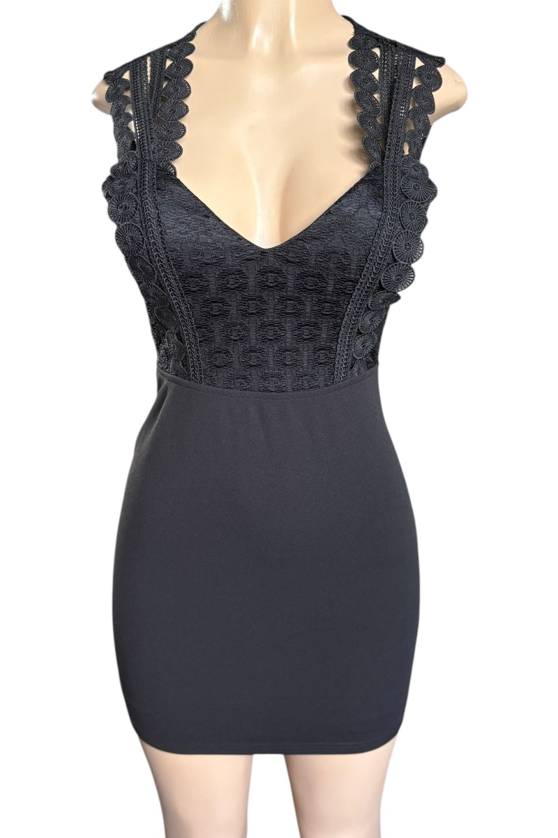 Black dress with lace details on a mannequin against a white background