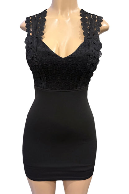 Black lace dress on a mannequin against a white background