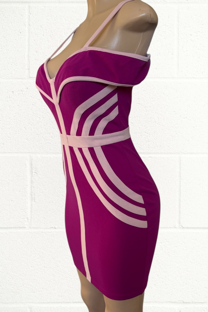pink dress with beige stripes on a mannequin against a white tiled wall.