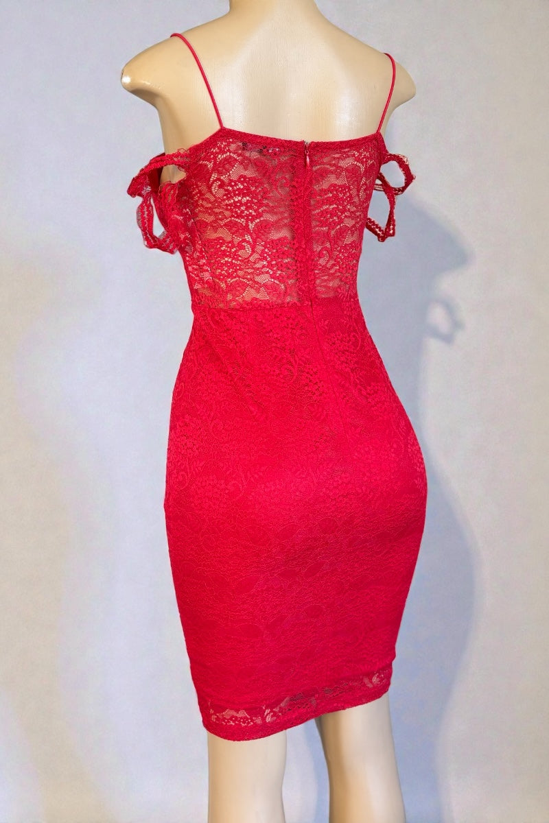 Red lace dress on a mannequin against a plain background
