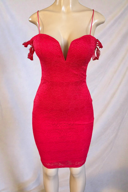 Red lace dress on a mannequin against a plain background