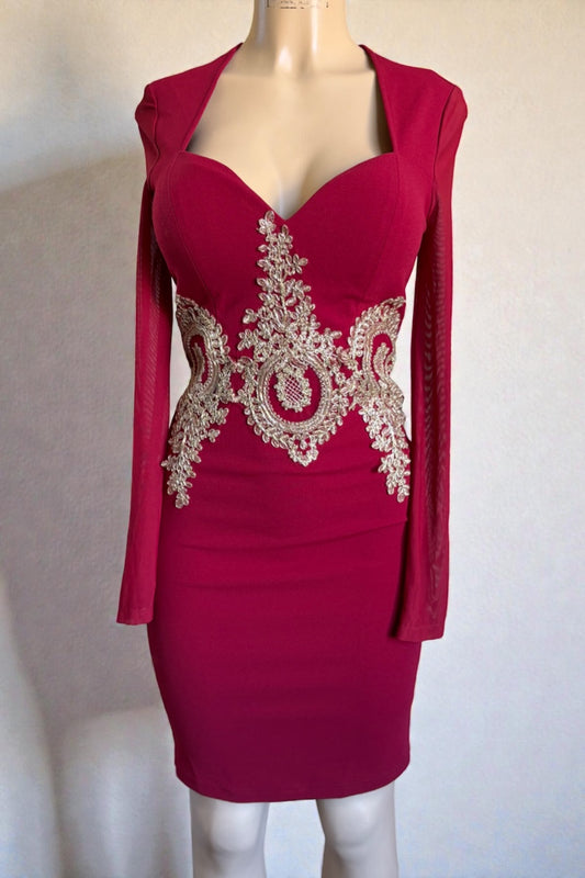 burgundy dress with gold embroidery on a mannequin against a plain background