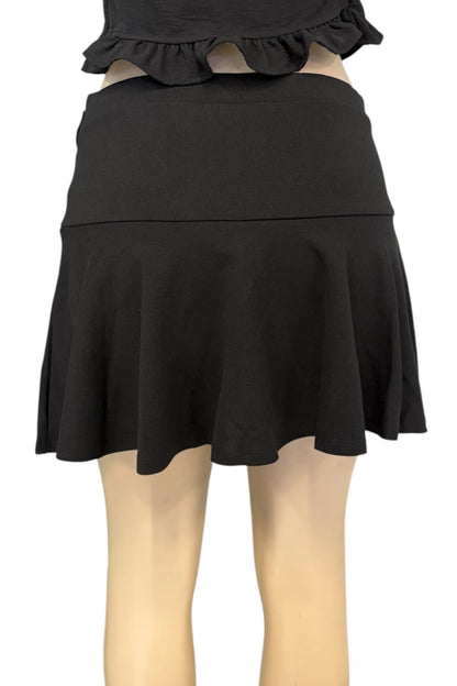 A black high-waisted mini skirt with a ruffled hem, shown on a mannequin against a plain white background.