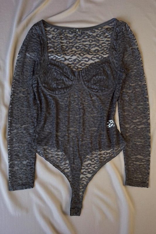 Black bodysuit with lace detailing on a white background