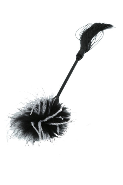Black and white feathered whip on a white background