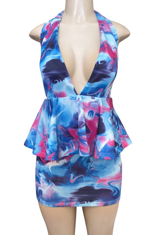 Colorful dress with abstract pattern on a mannequin against a white background