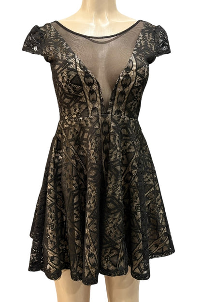 Black lace dress on a mannequin against a white background