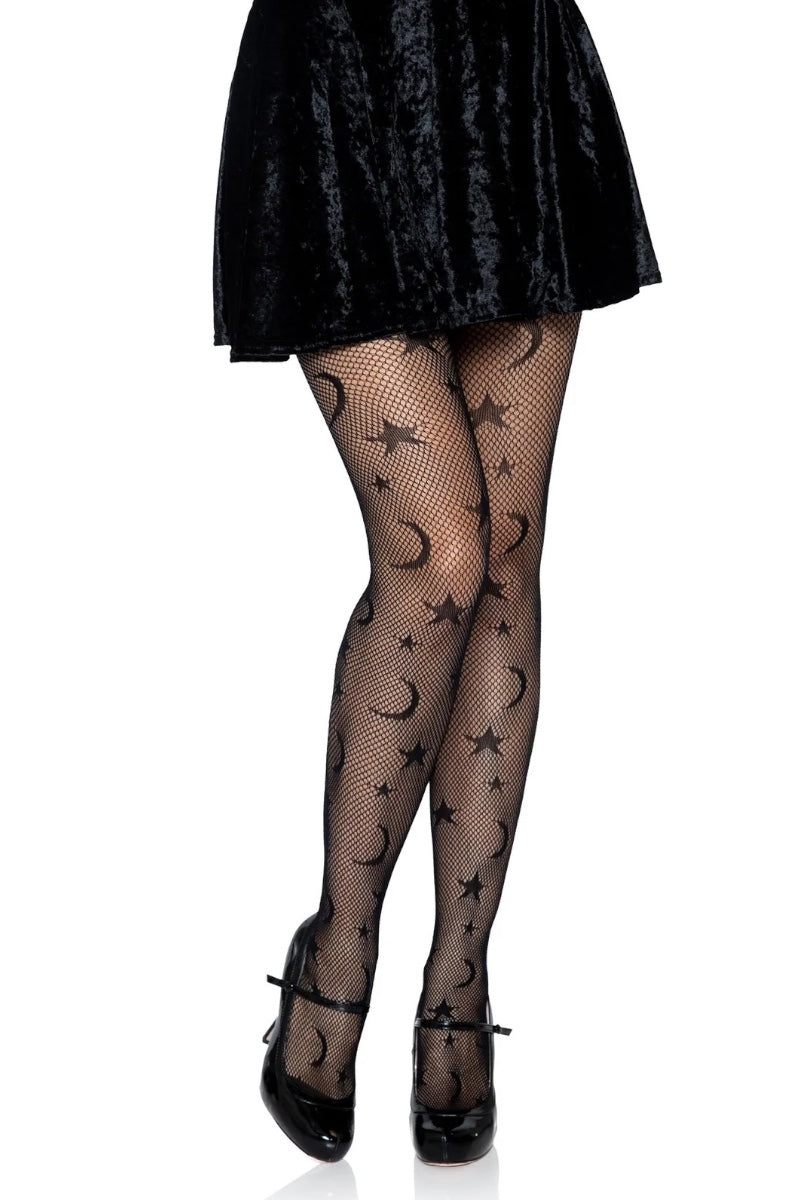 Black fishnet tights with a repeating star and crescent moon pattern, shown on a model's legs with a black skirt and black heels against a white background.