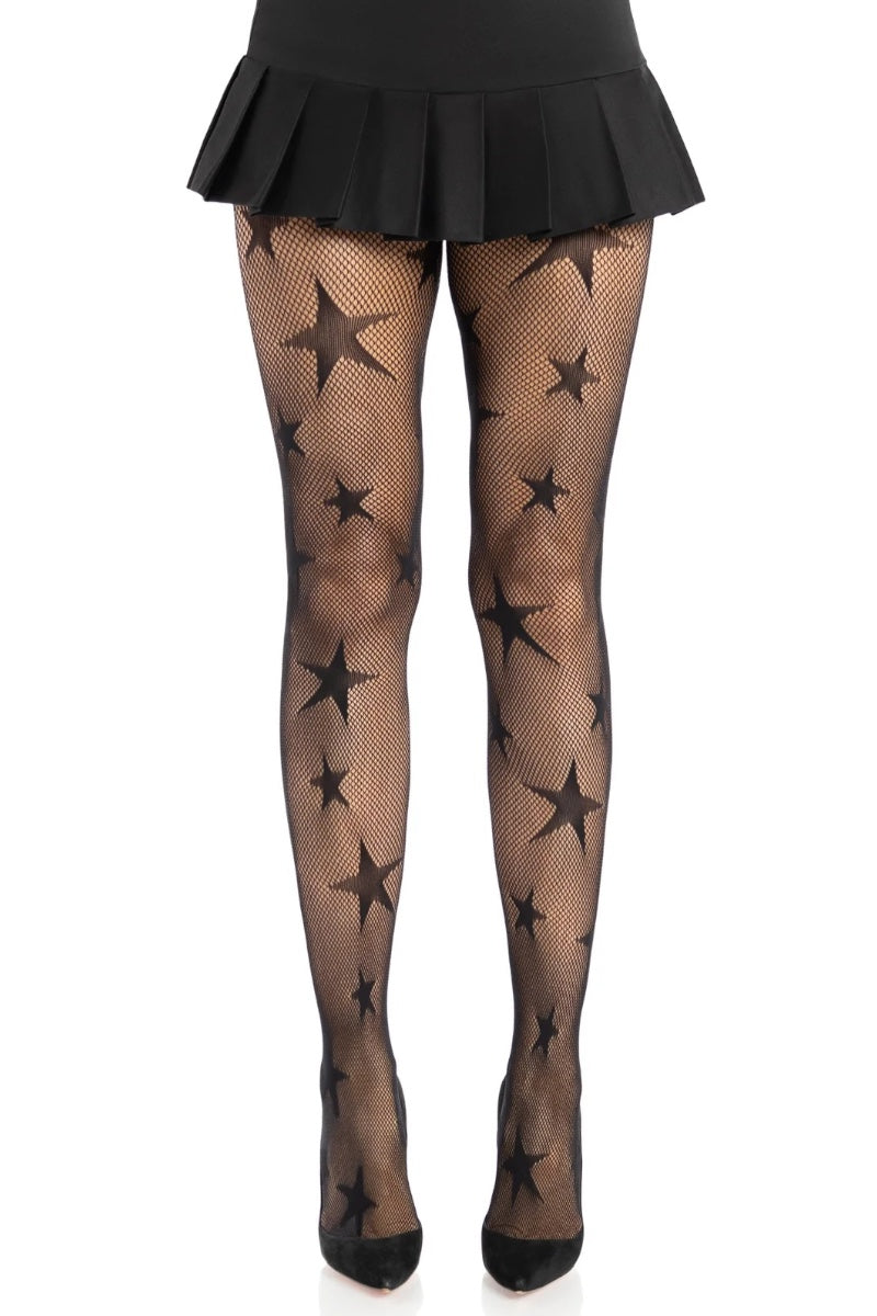 Black fishnet tights with a star pattern, shown on a model's legs with a black pleated skirt and black heels against a white background.