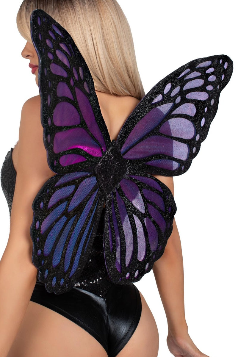 A woman shown from the back wearing a large butterfly wing costume accessory with black lace-like edges and purple to blue gradient wings against a plain white background.