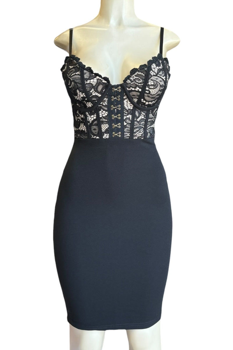 Black lace dress on a mannequin against a white background