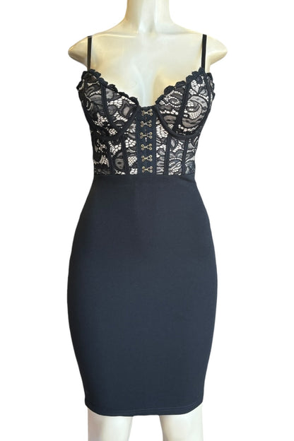 Black lace dress on a mannequin against a white background