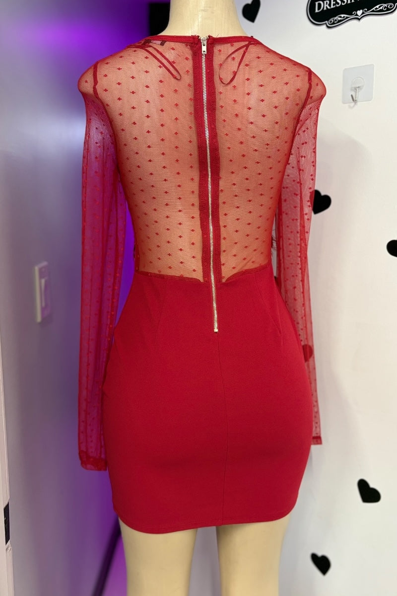 Red dress with sheer overlay on a mannequin against a white background