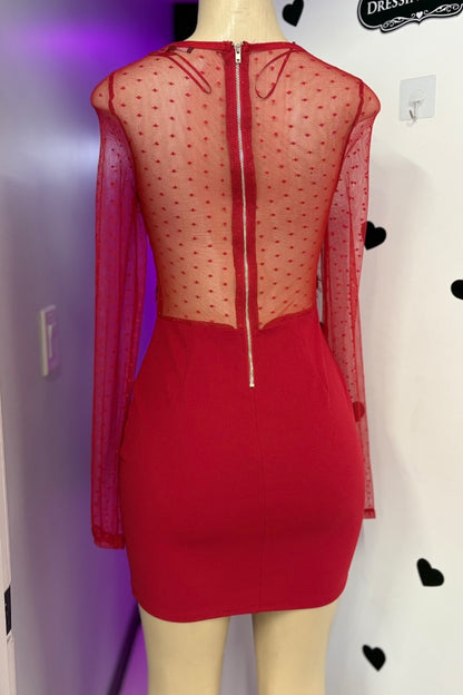Red dress with sheer overlay on a mannequin against a white background