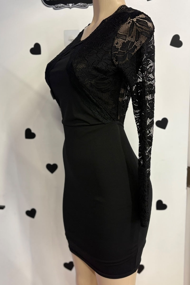 Black dress with lace sleeves on a mannequin against a white background with black heart shapes.