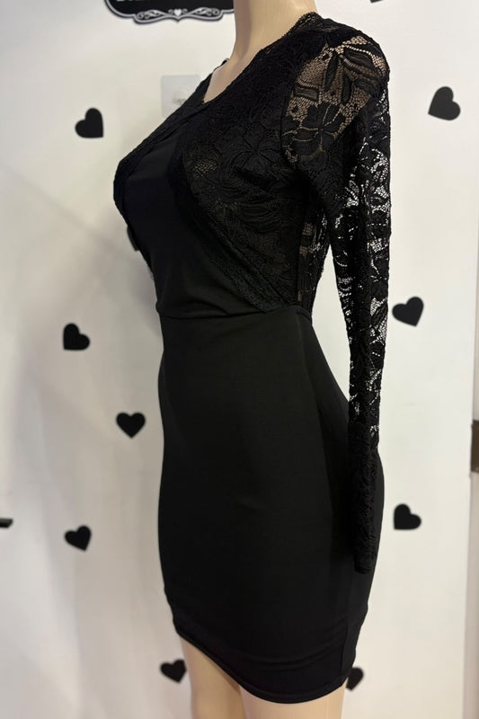 Black dress with lace sleeves on a mannequin against a white background with black heart shapes.