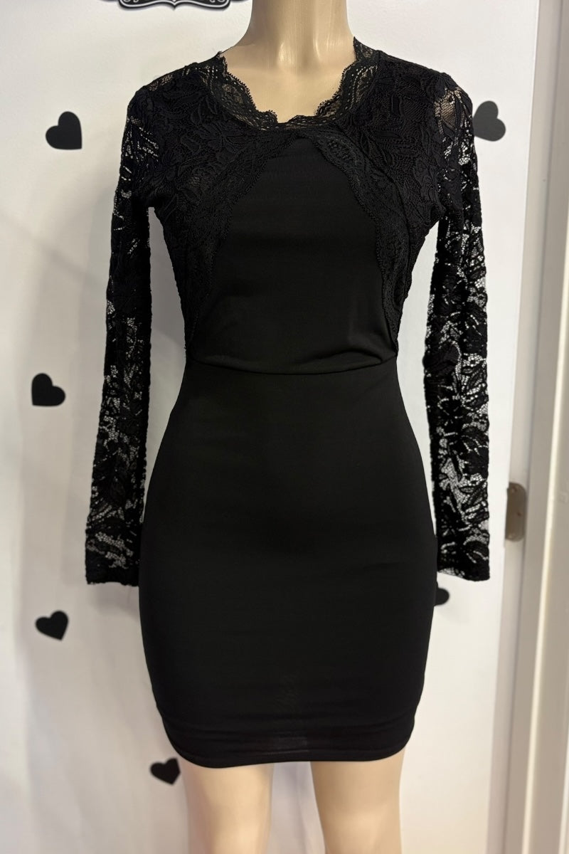 Black dress with lace sleeves on a mannequin against a white background