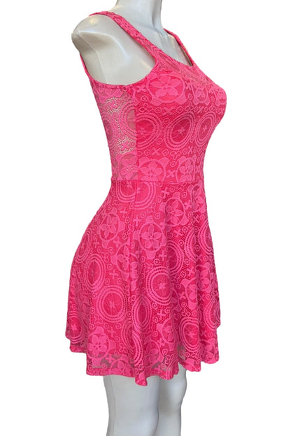 Pink lace dress on a mannequin against a white background