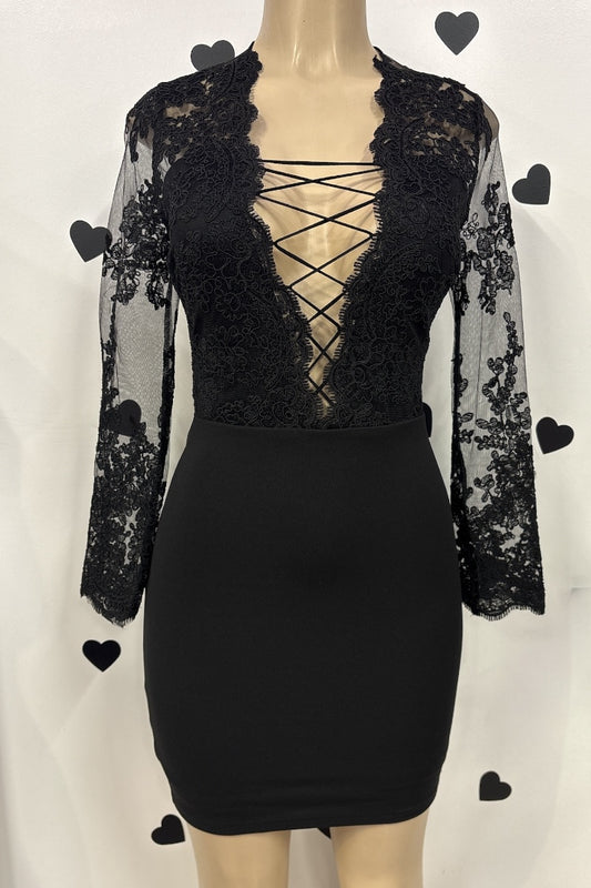 Black lace dress on a mannequin against a white background.
