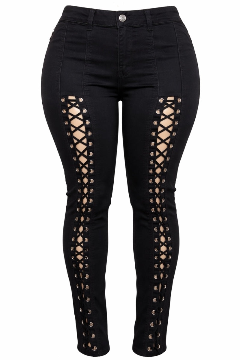 Black jeans with lace-up side panels on a white background
