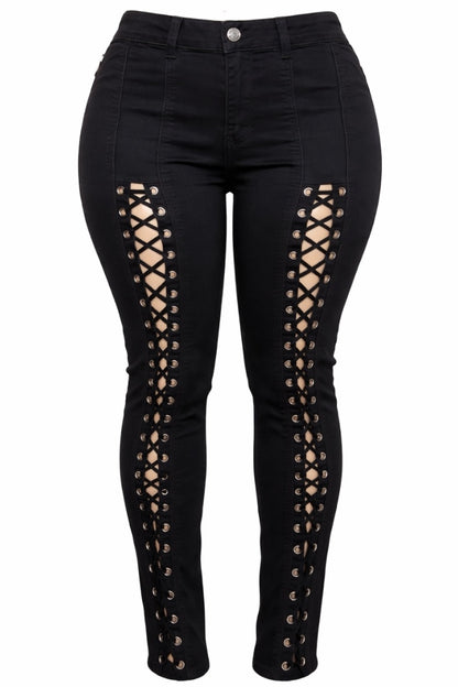 Black jeans with lace-up side panels on a white background