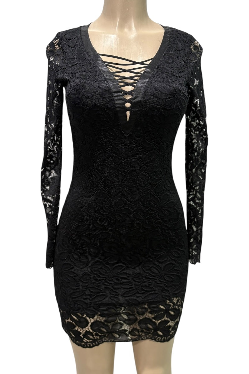 Black lace dress on a mannequin against a white background