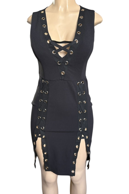 Black dress with gold eyelets on a mannequin against a white background