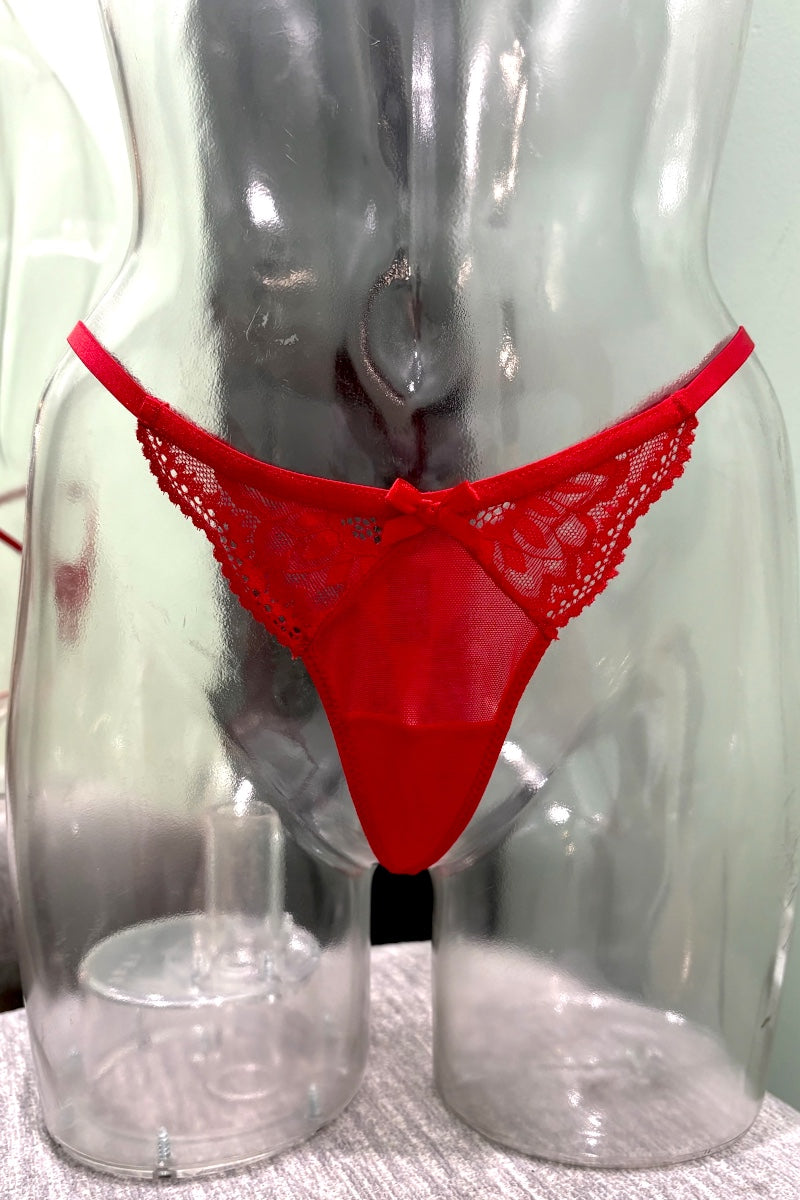Red lace thong underwear displayed on a clear plastic mannequin torso against a light background.
