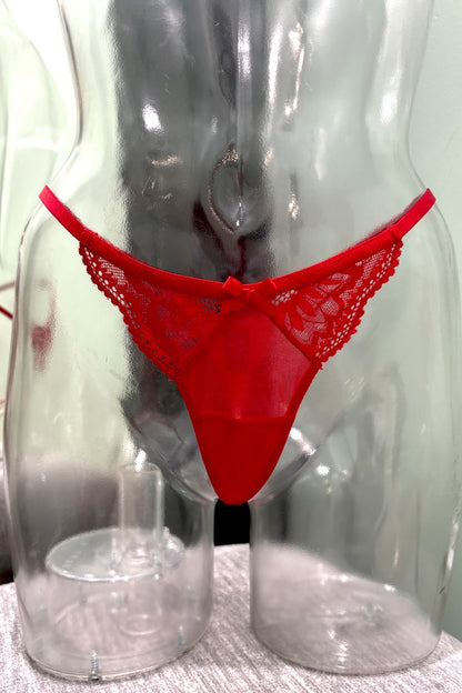 Red lace thong underwear displayed on a clear plastic mannequin torso against a light background.