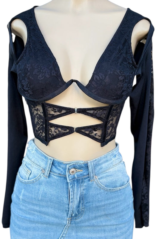 Black lace crop top with cut-out design on a mannequin with a blue skirt.