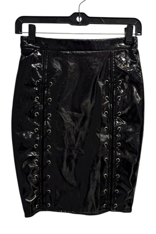 Black lace-up skirt on a hanger against a white background