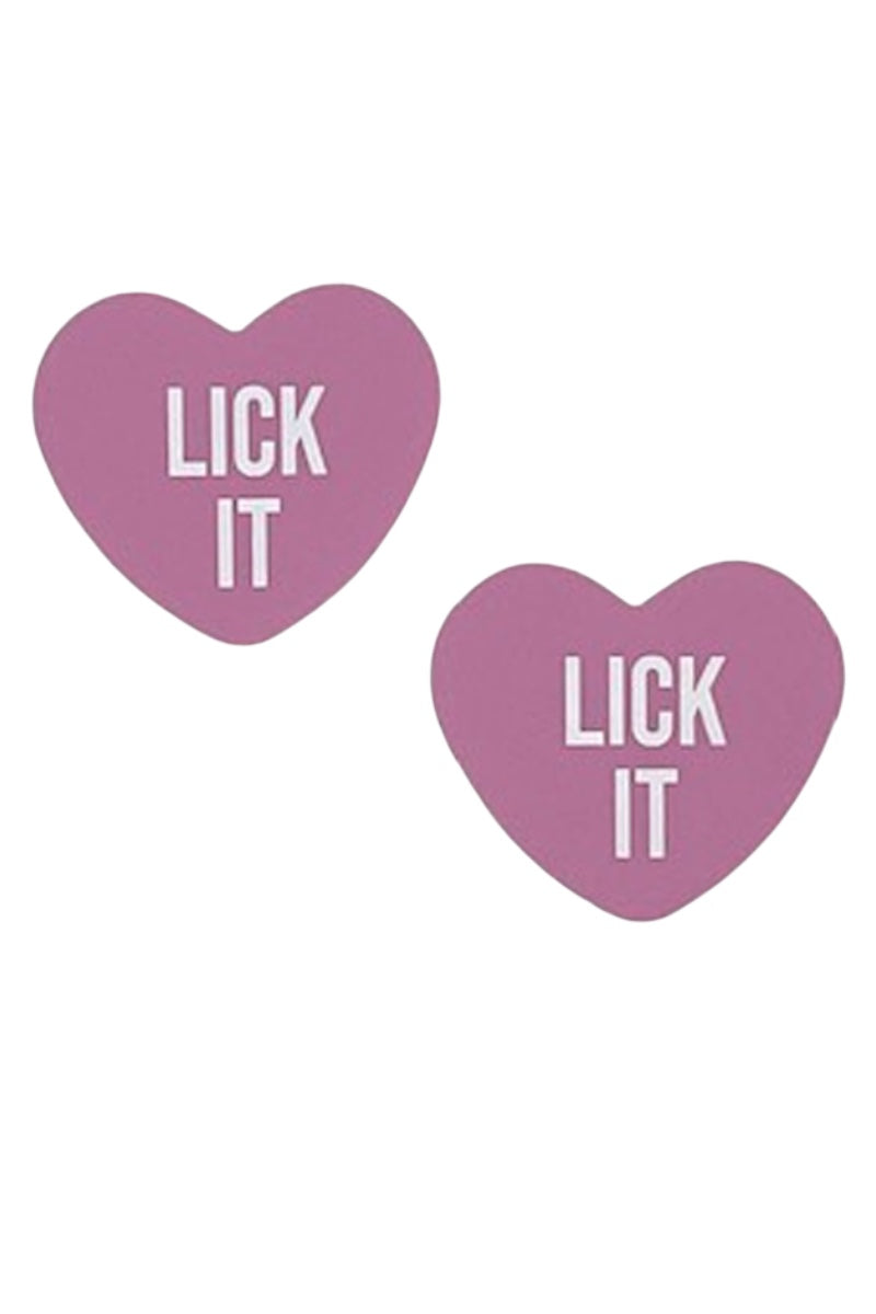 Two pink heart-shaped pasties with 'LICK IT' text on a white background