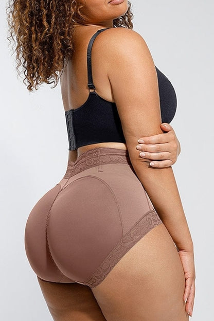 Person wearing a black sports bra and cocoa high-waisted shaper underwear on a white background