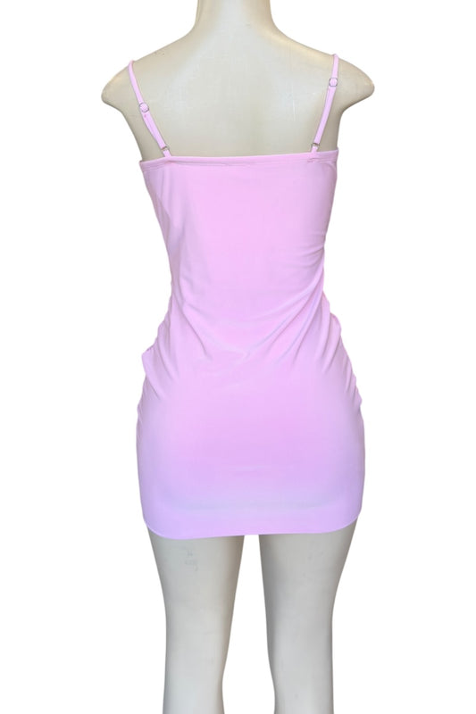Pink dress on a mannequin against a white background