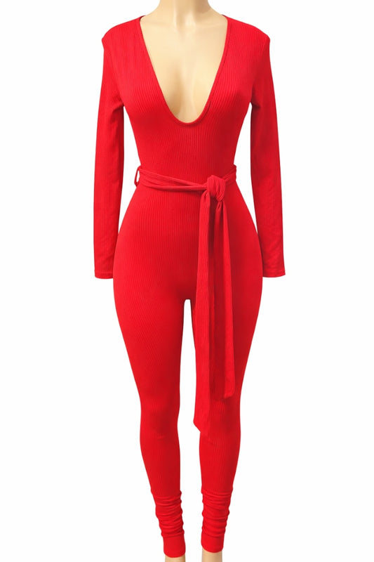 Red jumpsuit with a deep neckline and tie waist on a white background