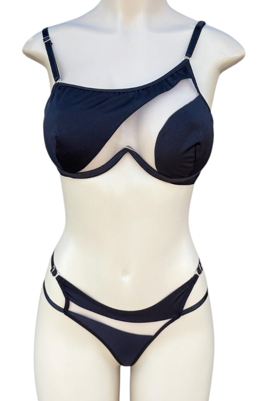black bra top and panties set on a mannequin against a white background