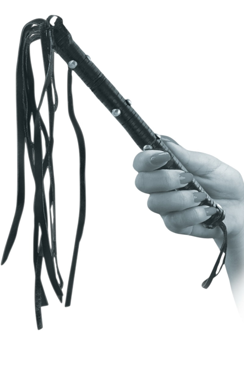 Black leather whip held by a hand on a white background