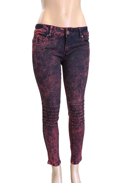 Red and black patterned jeans on a mannequin against a white background